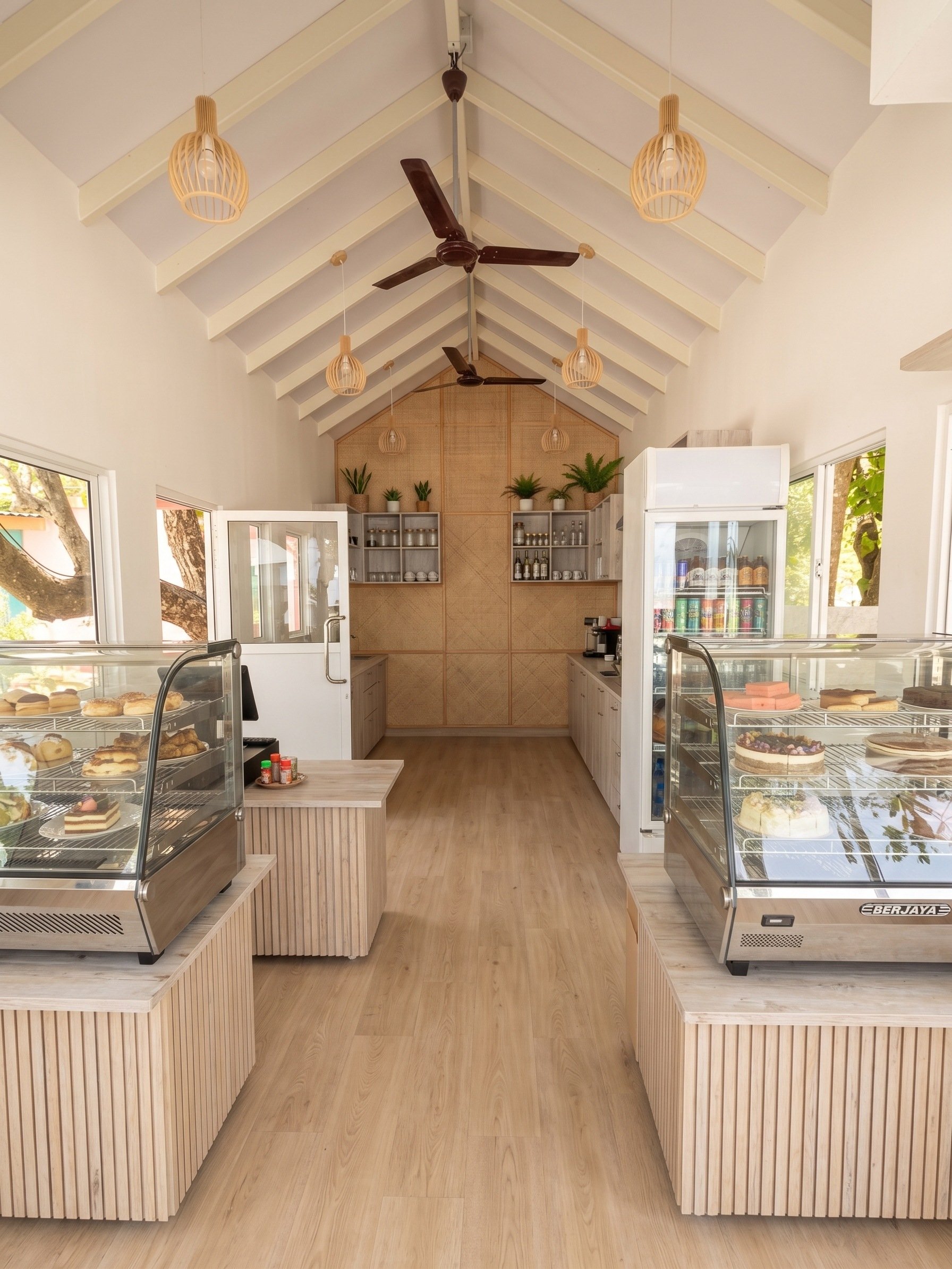 Render of the service area with pale timber, a woven rattan wall and display cases